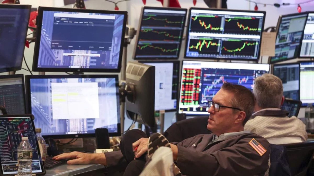 Pantallas de la bolsa de Nueva York muestran la caida de las acciones de Apple en Wall Street