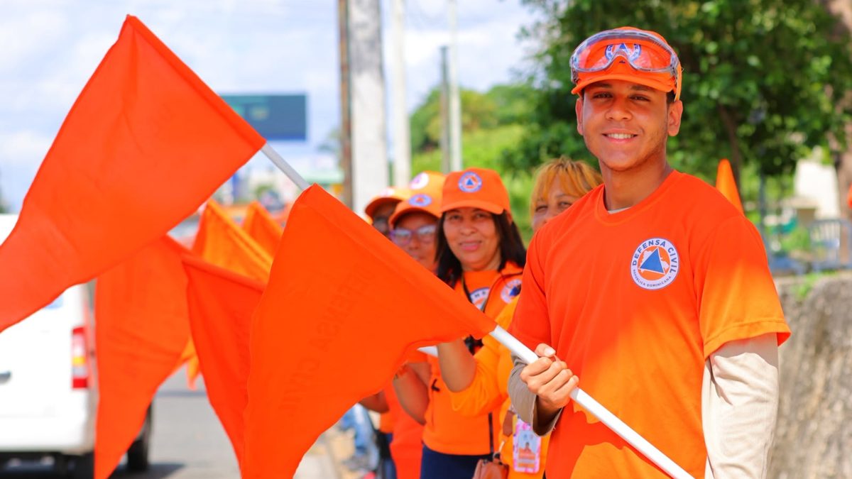 Voluntarios de la Defensa Civil Dominicana con uniformes naranja listos para operativo de emergencia