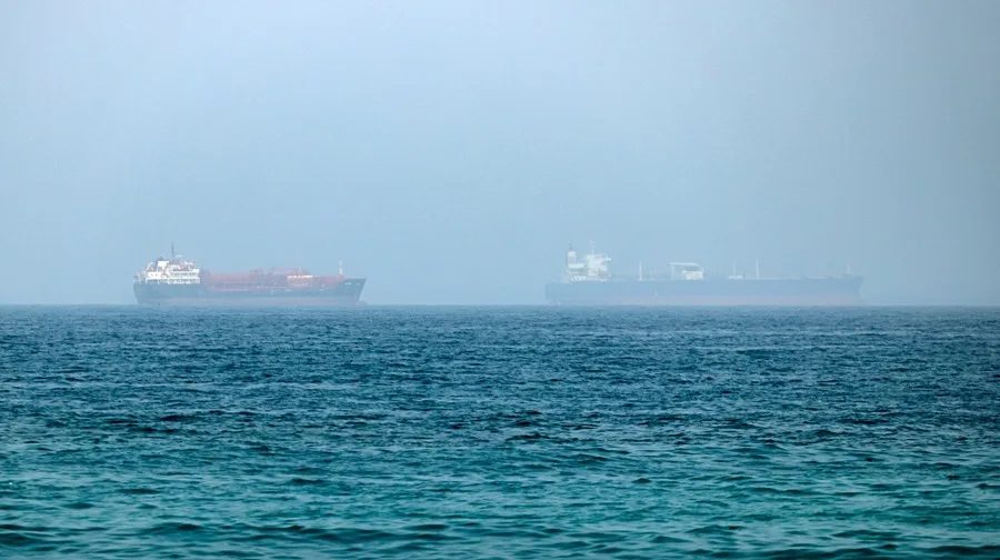Petrolero en llamas en el estrecho de Ormuz con columnas de humo negro sobre el mar