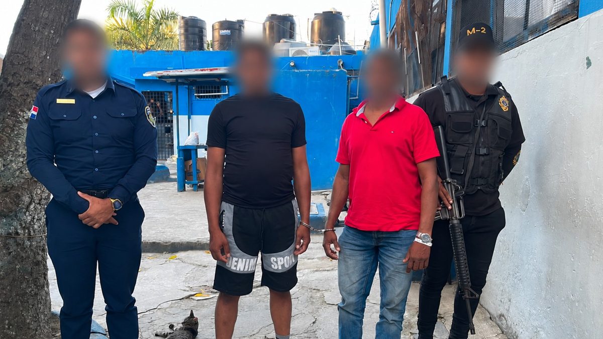 Agentes de la Armada dominicana junto a una embarcación interceptada con migrantes en el mar Caribe