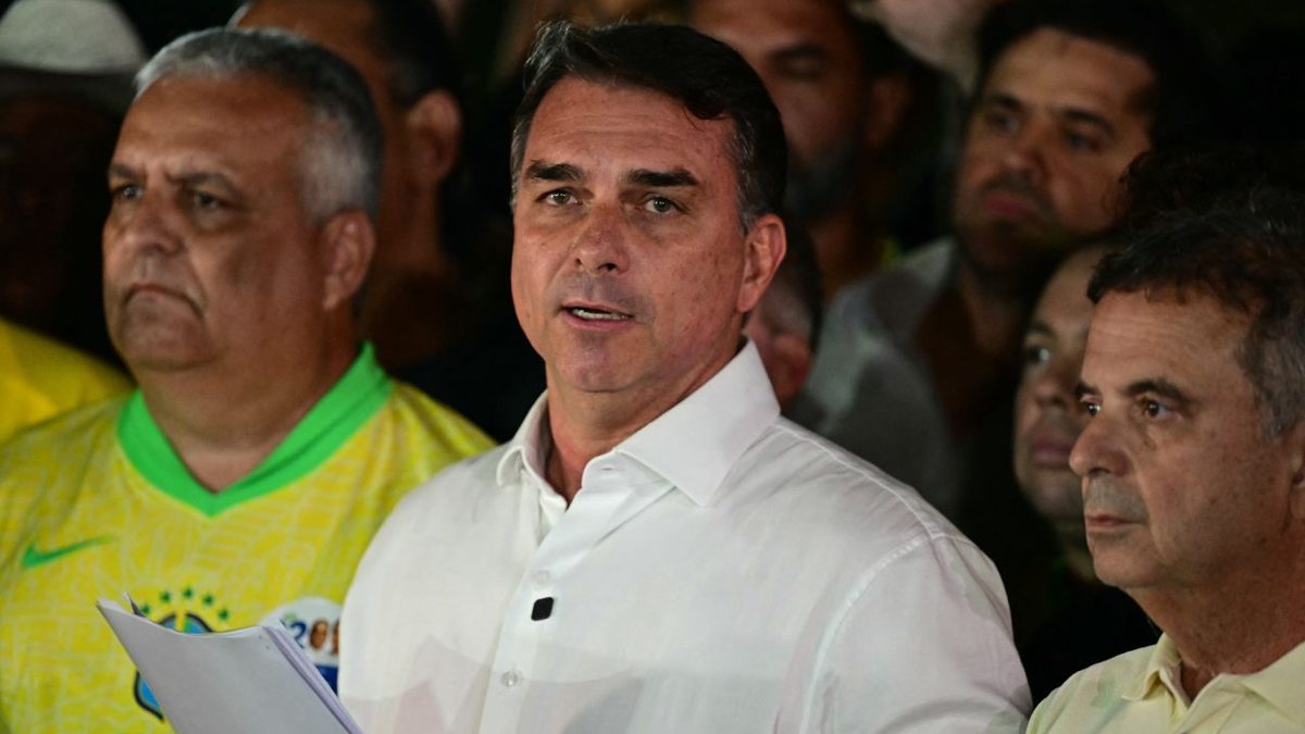 Flávio Bolsonaro hablando ante micrófonos en Brasilia tras los resultados de la segunda vuelta presidencial de Brasil